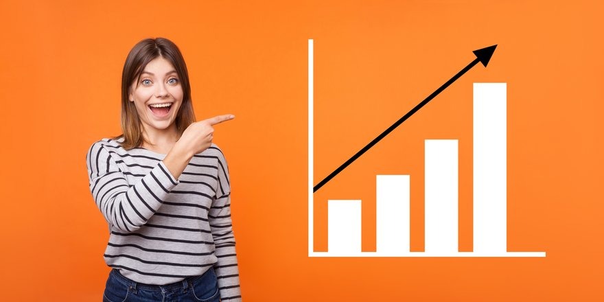 Happy client looking at financial charts showing positive growth